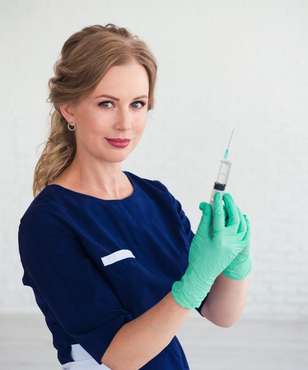 young-woman-cosmetologist-in-blue-uniform-holding-syringe-beauty-face-injection.jpg